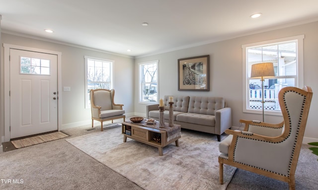 living area featuring recessed lighting, baseboards, crown molding, and light colored carpet