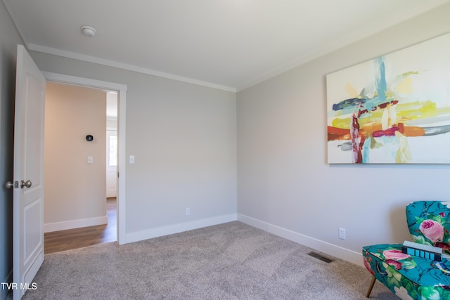 interior space with crown molding, baseboards, visible vents, and light colored carpet