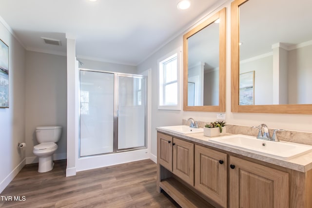 full bath with crown molding, a sink, visible vents, and a shower stall