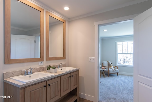 full bathroom with crown molding, baseboards, and a sink