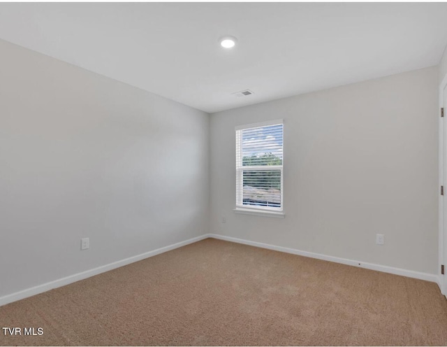 unfurnished room with light colored carpet