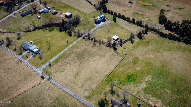 birds eye view of property with a rural view