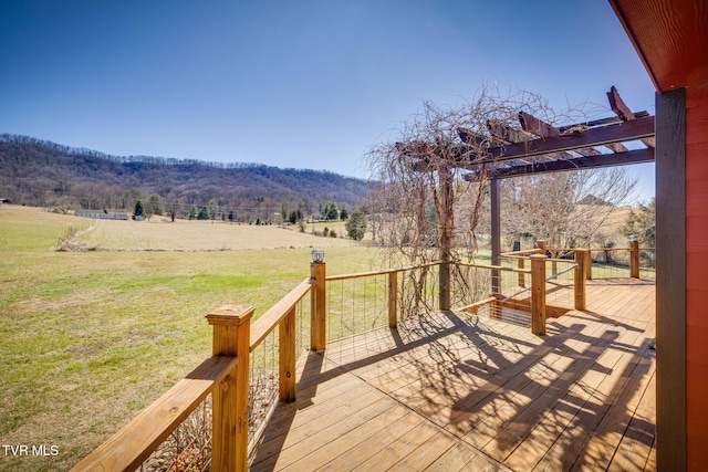 deck featuring a rural view, a pergola, and a yard