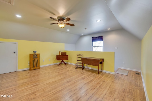 additional living space with baseboards, visible vents, ceiling fan, vaulted ceiling, and light wood-style floors