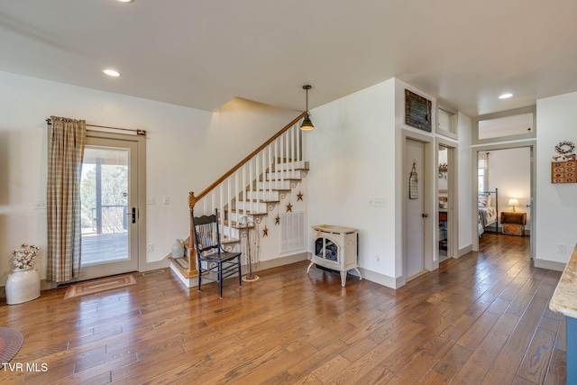 foyer entrance with stairs, wood-type flooring, visible vents, and recessed lighting