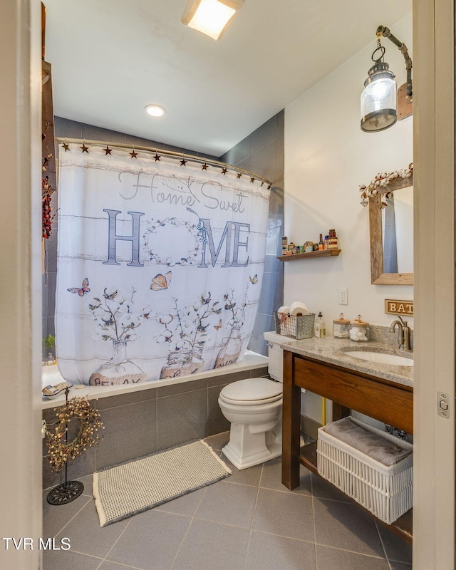 bathroom featuring shower / bath combination with curtain, tile patterned flooring, vanity, and toilet