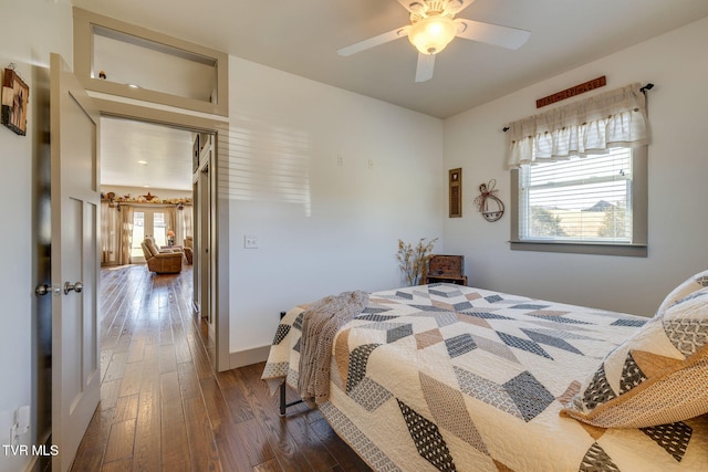 bedroom featuring ceiling fan, dark wood-type flooring, and baseboards