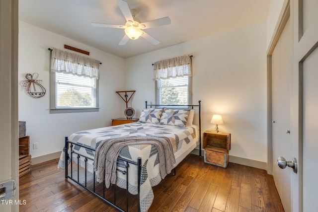 bedroom featuring a closet, wood-type flooring, ceiling fan, and baseboards