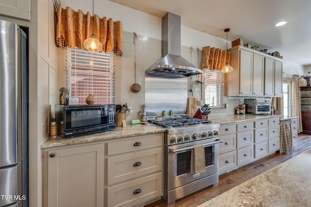 kitchen with a toaster, stainless steel appliances, wood finished floors, wall chimney range hood, and decorative backsplash