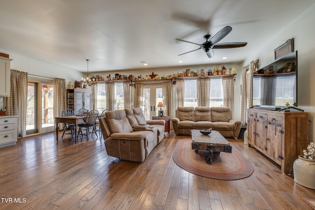 living area with ceiling fan with notable chandelier, french doors, wood-type flooring, and recessed lighting