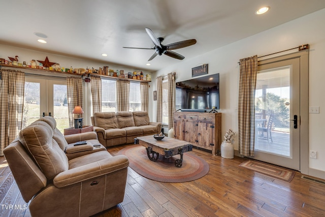 living room featuring recessed lighting, visible vents, hardwood / wood-style floors, and french doors