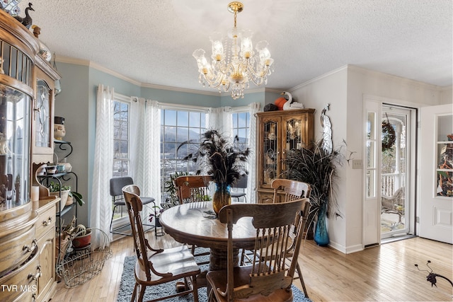 dining space with light wood-type flooring, a chandelier, crown molding, and a textured ceiling