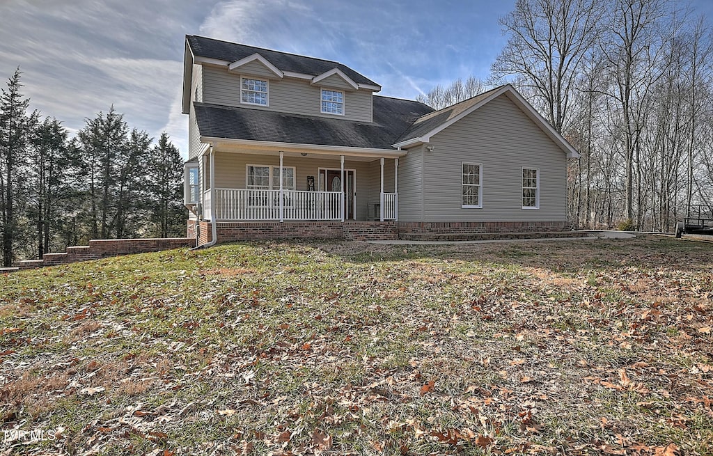 view of front of home with a front yard and covered porch