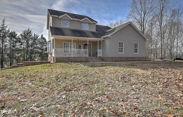 view of front of home with a front yard and covered porch