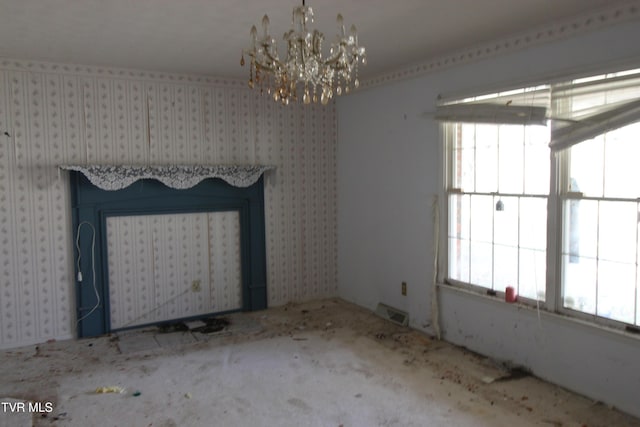 interior space featuring a fireplace, plenty of natural light, and a notable chandelier