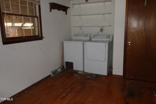 washroom featuring dark hardwood / wood-style floors and washing machine and clothes dryer