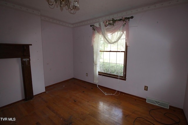 unfurnished dining area featuring an inviting chandelier and wood-type flooring