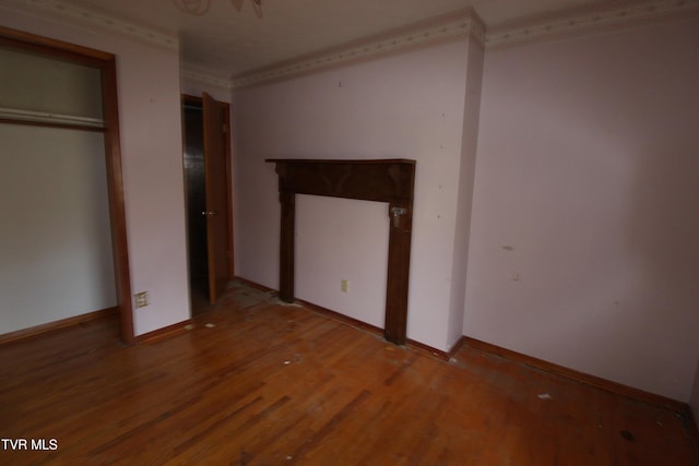 unfurnished bedroom featuring ornamental molding and hardwood / wood-style floors