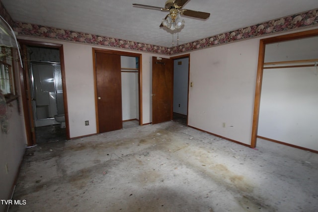 unfurnished bedroom featuring ensuite bath and multiple closets