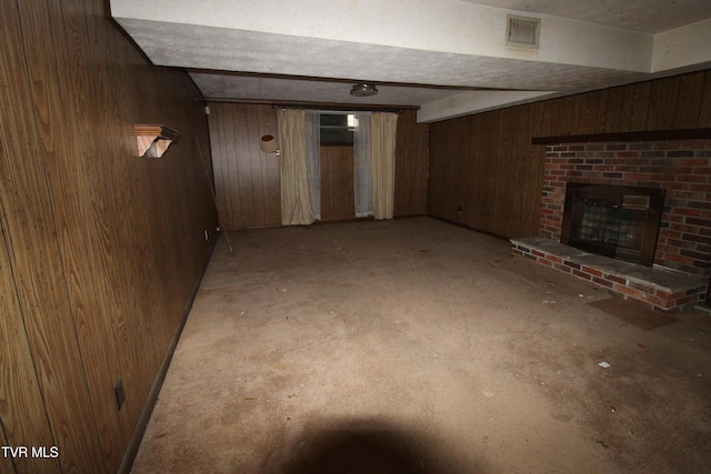 basement with a fireplace and wooden walls