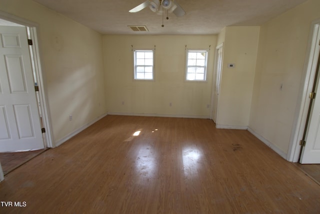 spare room featuring ceiling fan and light hardwood / wood-style flooring