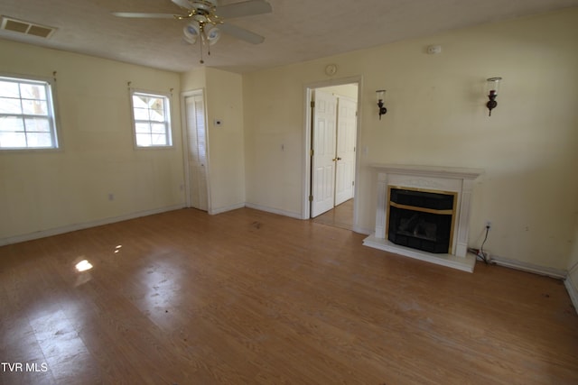 unfurnished living room with light hardwood / wood-style floors and ceiling fan