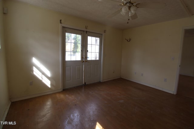 foyer featuring ceiling fan, french doors, wood-type flooring, and a textured ceiling