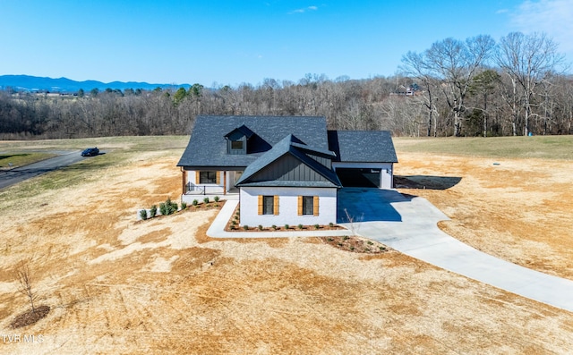 294 River Pointe Dr, Greeneville, TN 37743 - modern inspired farmhouse featuring concrete driveway, a shingled roof, board and batten siding, and a view of trees