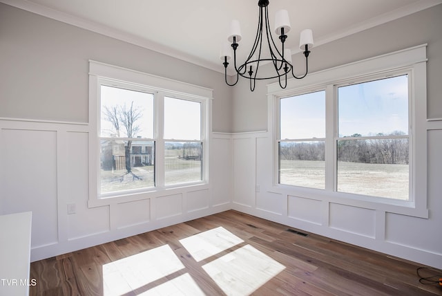 294 River Pointe Dr, Greeneville, TN 37743 - unfurnished dining area featuring visible vents, a decorative wall, ornamental molding, wood finished floors, and a chandelier