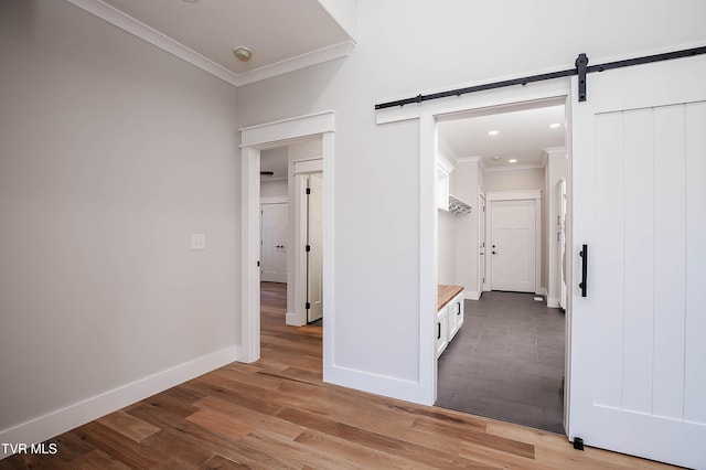 294 River Pointe Dr, Greeneville, TN 37743 - hallway featuring a barn door, ornamental molding, light wood-style flooring, and baseboards