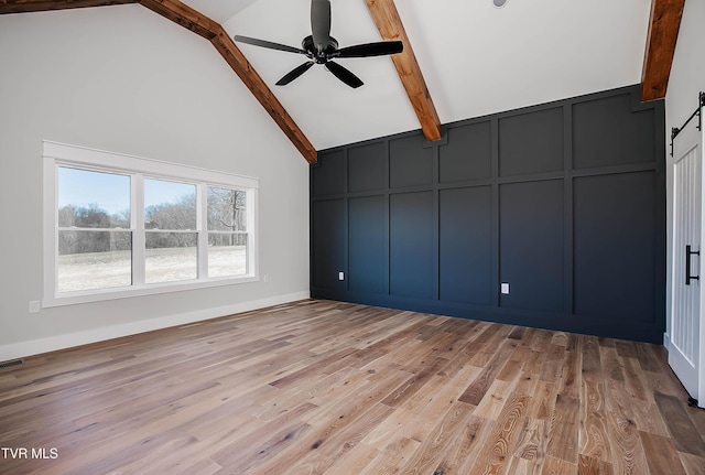 294 River Pointe Dr, Greeneville, TN 37743 - spare room with a decorative wall, light wood-style floors, ceiling fan, high vaulted ceiling, and beamed ceiling