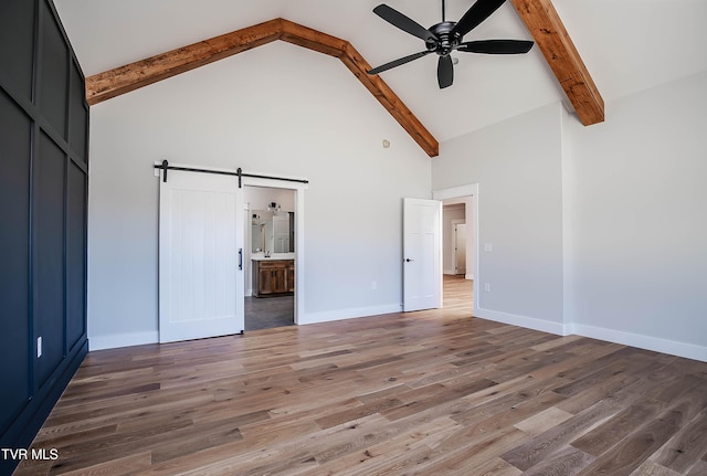 294 River Pointe Dr, Greeneville, TN 37743 - unfurnished bedroom featuring a barn door, baseboards, beamed ceiling, light wood-type flooring, and high vaulted ceiling