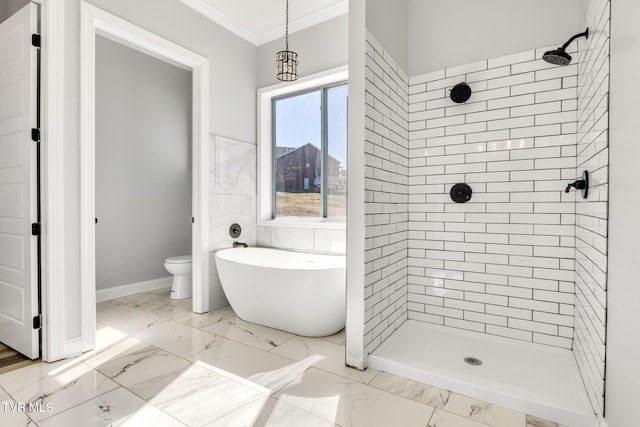 bathroom with marble finish floor, a freestanding tub, crown molding, and a stall shower