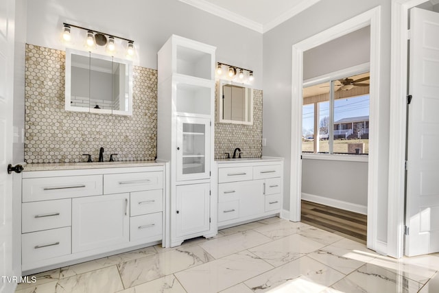 bathroom featuring a ceiling fan, vanity, marble finish floor, decorative backsplash, and crown molding