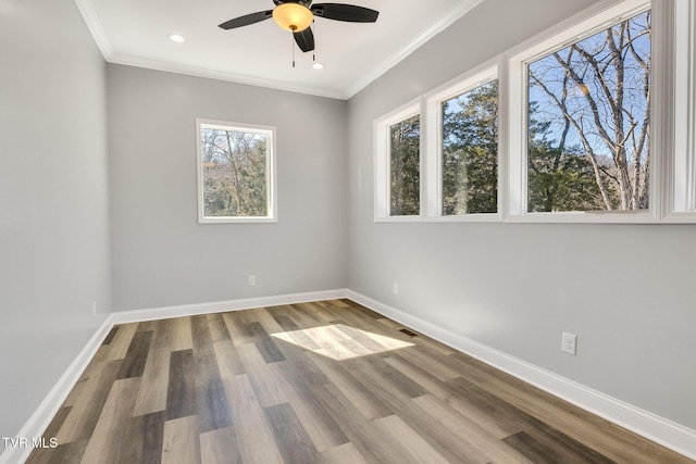 unfurnished room featuring recessed lighting, wood finished floors, a ceiling fan, baseboards, and ornamental molding