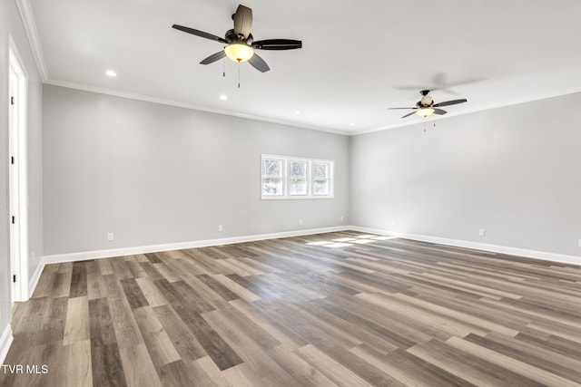 spare room featuring ornamental molding, wood finished floors, and baseboards