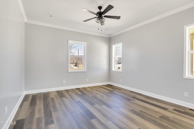 spare room featuring a ceiling fan, baseboards, crown molding, and wood finished floors