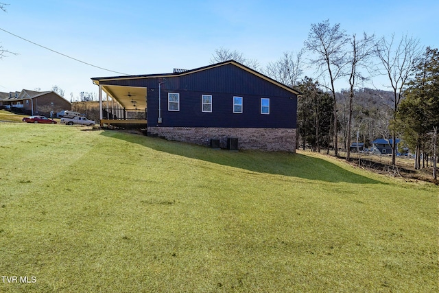 view of property exterior with a yard and a ceiling fan