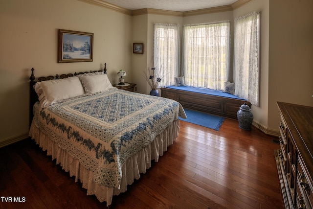 bedroom featuring baseboards, ornamental molding, and dark wood-style flooring