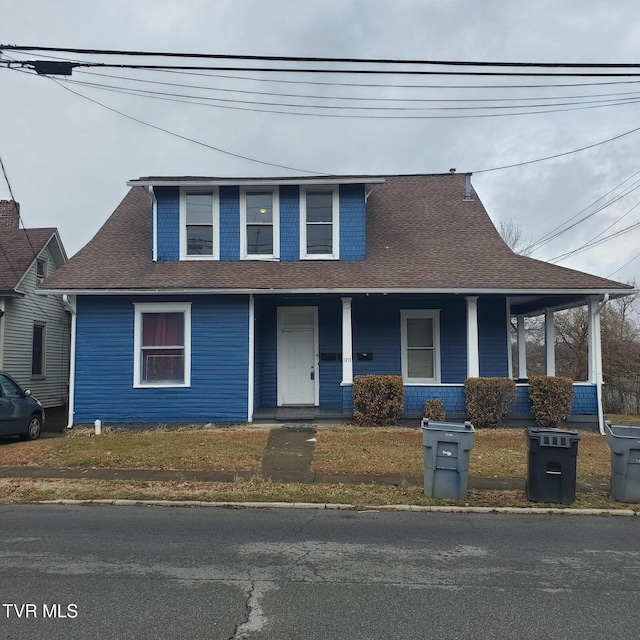 view of front of house with a porch and a front yard