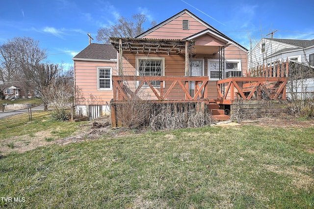 back of property featuring a yard and a wooden deck