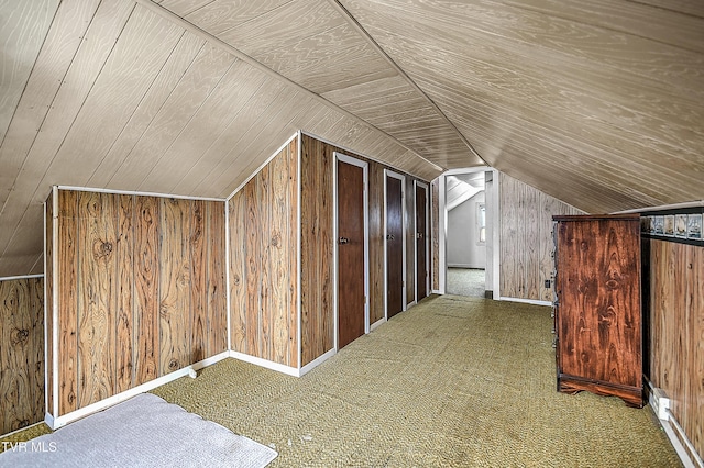 additional living space featuring carpet, vaulted ceiling, wood ceiling, and wood walls