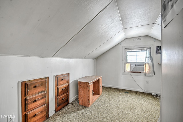 additional living space with cooling unit, lofted ceiling, and carpet flooring