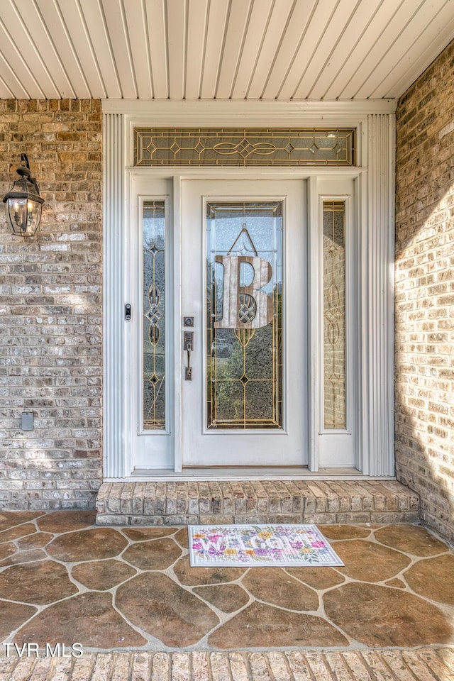 property entrance with brick siding