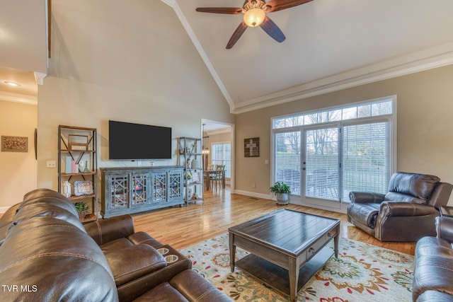 living room featuring ornamental molding, light wood-style floors, high vaulted ceiling, and ceiling fan