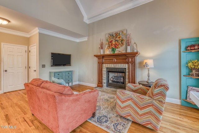 living room with light wood-style floors and crown molding