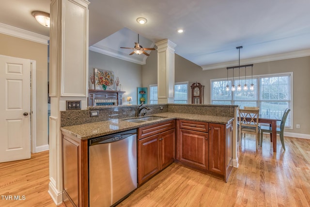 kitchen with a sink, dark stone counters, brown cabinets, and dishwasher