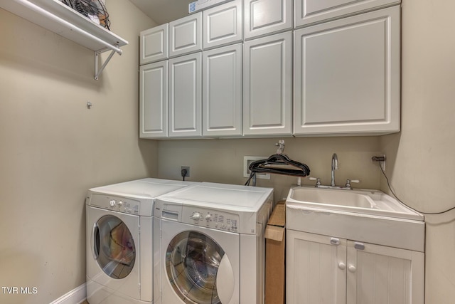 laundry room featuring a sink, washing machine and dryer, and cabinet space