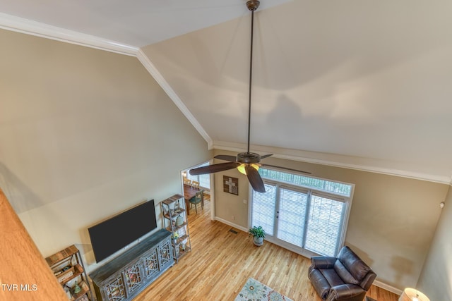 living area featuring vaulted ceiling, ceiling fan, light wood-style floors, and crown molding