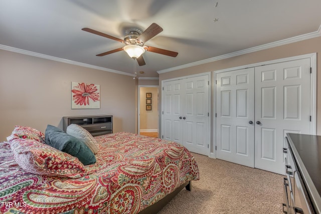 bedroom featuring multiple closets, light colored carpet, and ornamental molding